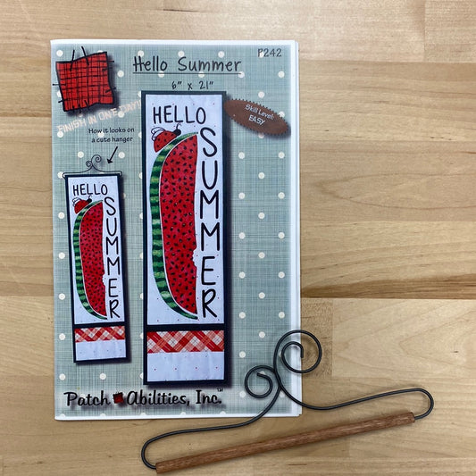 Get ready to say "Hello Summer" (P242) in the most fun and unique way with our mini quilt and applique project by PatchAbilities! This cute design features a long watermelon slice and a playful ladybug. Photo shows the front pattern cover with included scroll hanger.