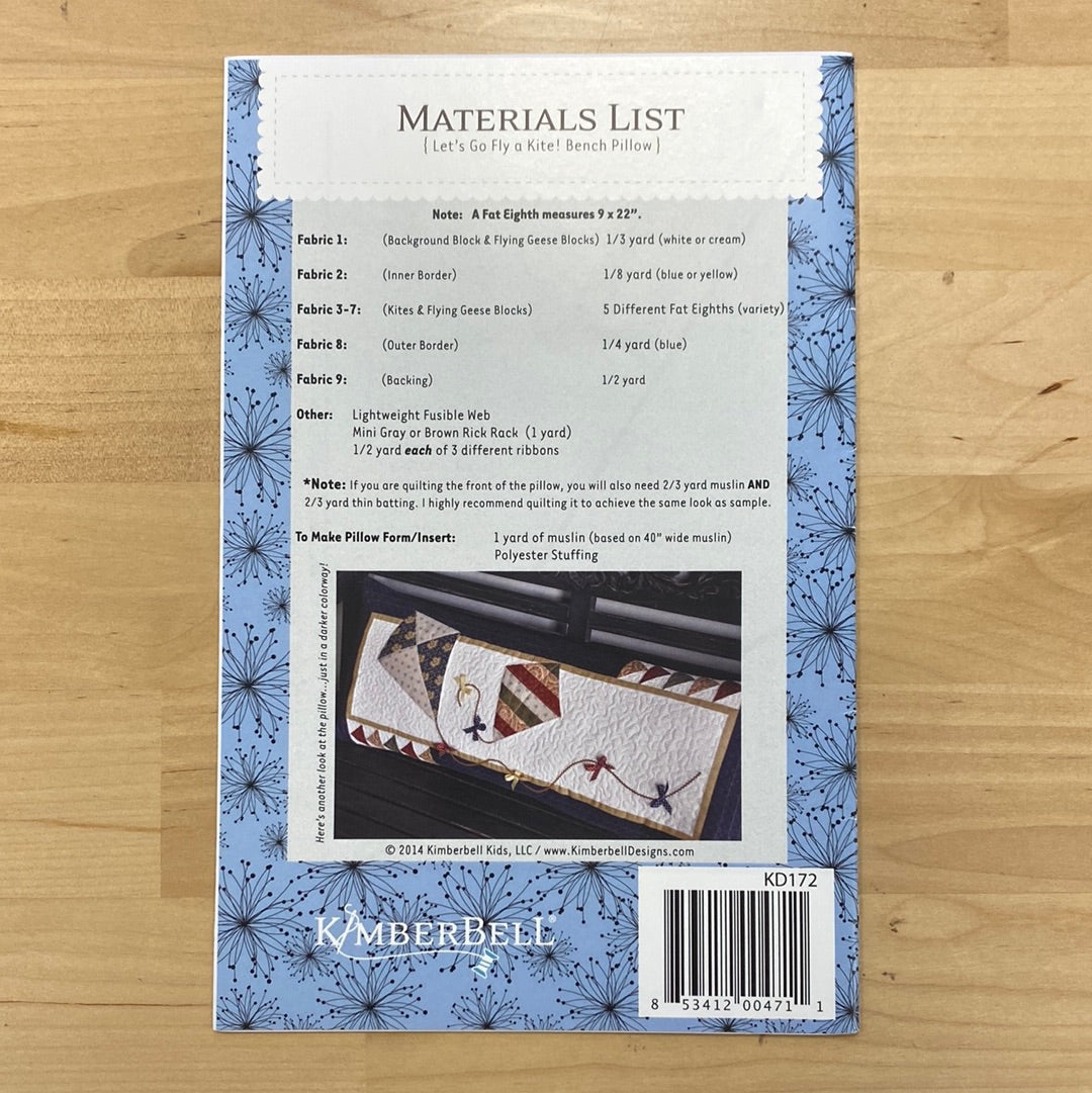 Get ready to soar with the Let's Go Fly A Kite! Bench Pillow Pattern (KD172) by Kimberbell! This playful pattern features a flying geese pieced border and adorable kites with ribbon embellished tails. Photo features the back of the package.