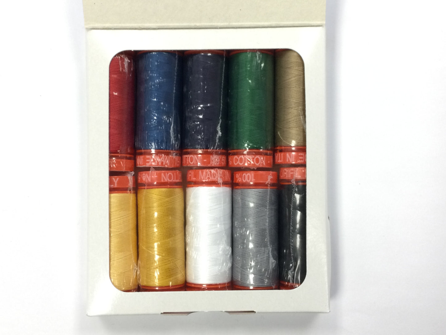 Kimberbell Red, White & Bloom thread set thread detail in packaging. Colors include one shade each of red, white, gray, and black, two shades each of dark blue, green, and yellow.