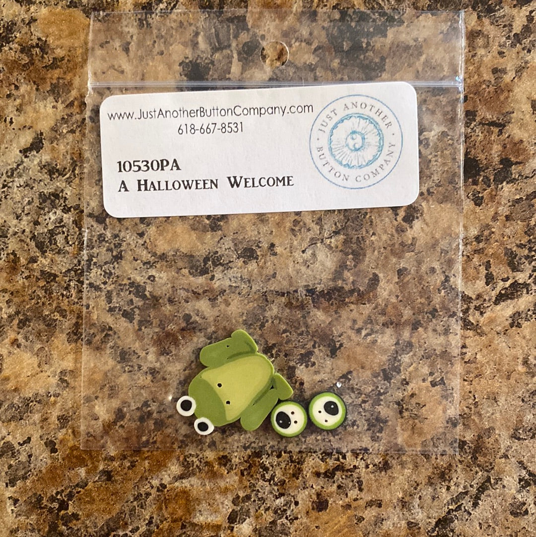 Add a spooky touch to your home with the Halloween Welcome with Buttons (P249B) by PatchAbilities! With a frog, spider, pumpkin, and broom, this fun and easy project is sure to get all the frightful fun of Halloween. The picture shows the frog and eyeball buttons that are included.
