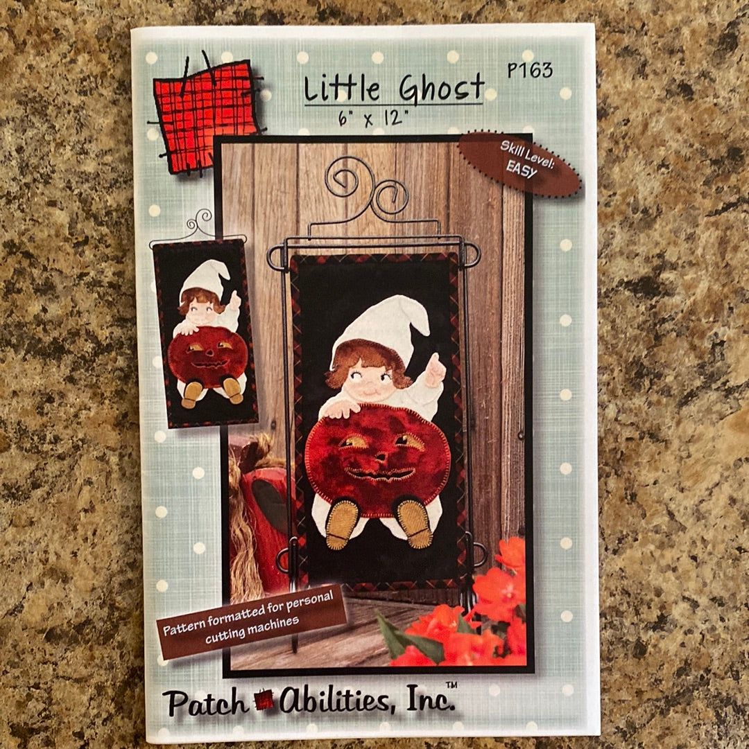 Spook up your holiday with our Little Ghost Pattern (P163) by Patch Abilities! This easy mini quilt applique pattern features a playful girl dressed in a ghost costume, holding a jack o' lantern.