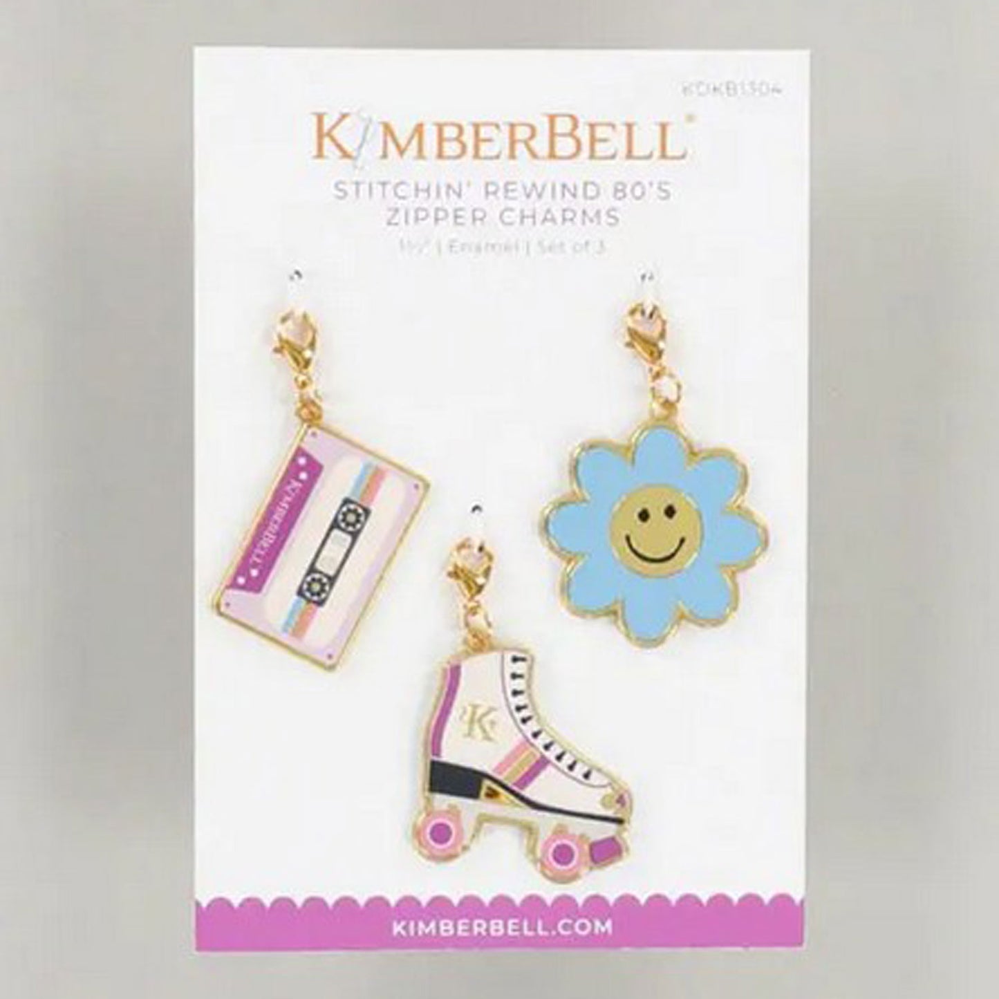Kimberbell’s Stitchin’ Rewind 80’s Zipper Charms (KDKB1304) are a pack of three lobster clasp charms that include a flower, a mix tape, and a roller skate to delight your 1980's soul. The photo shows the front package including each of the charms.