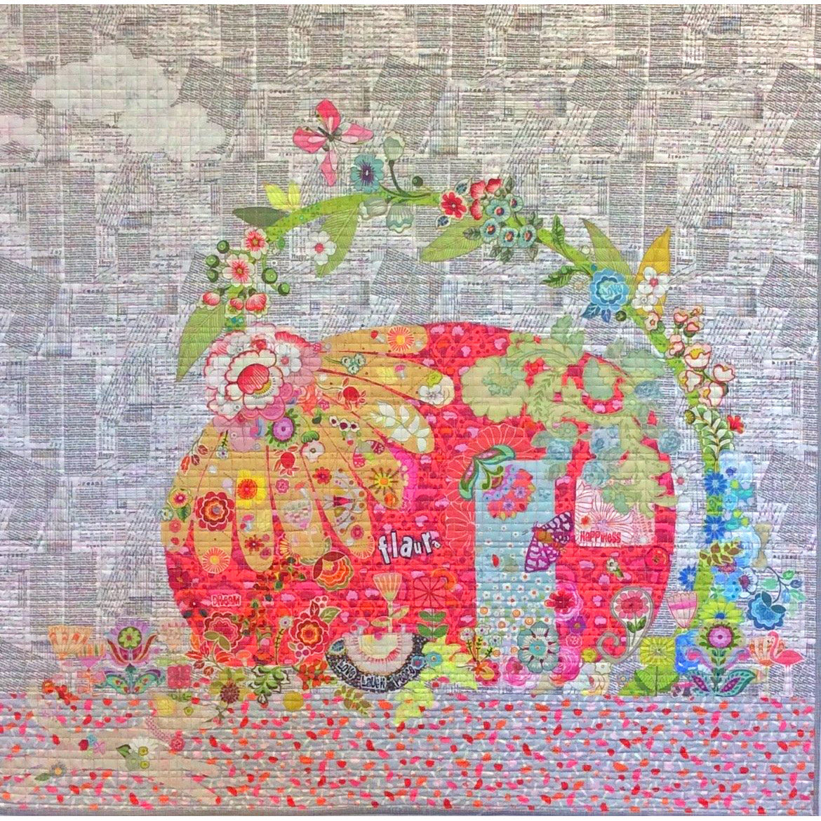 Capture a fun vintage vibe with this Flaura Collage Pattern by Laura Heine! Featuring a vintage camper and trailer, the pattern helps you create a unique quilt that's full of retro-inspired charm. The photo shows the finished project.