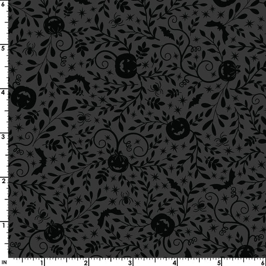 The Pumpkin Vines in black (MAS10572-J) print from the Pumpkin and Potions line by Kimberbell for Maywood Studio features tone on tone pumpkins, bats, and more. Photo shows details of the designs with a ruler to show the scale.