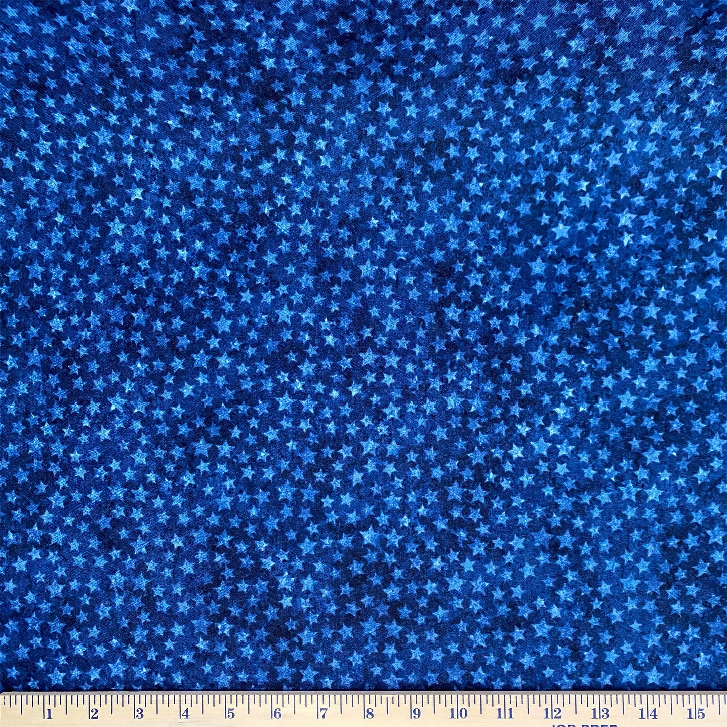 The tone on tone stars in navy celebrate 10 years of Stonehenge Stars & Stripes designed by Linda Ludovico for Northcott Fabrics. The versatile small stars on multi-blue shaded and mottled background was designed in support of Quilts of Valor, but this non-directional blender fabric adds a bold accent to any project.
