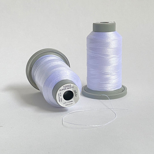 Glide 40 wt. Trilobal polyester thread by Fil-Tec offers superior coverage and strength on each 1,100 yard mini spool. Super White (10002) is a bright white and it's sheen makes it perfect for capturing glistening snow or any other pure white scene. Stitcher's Joy