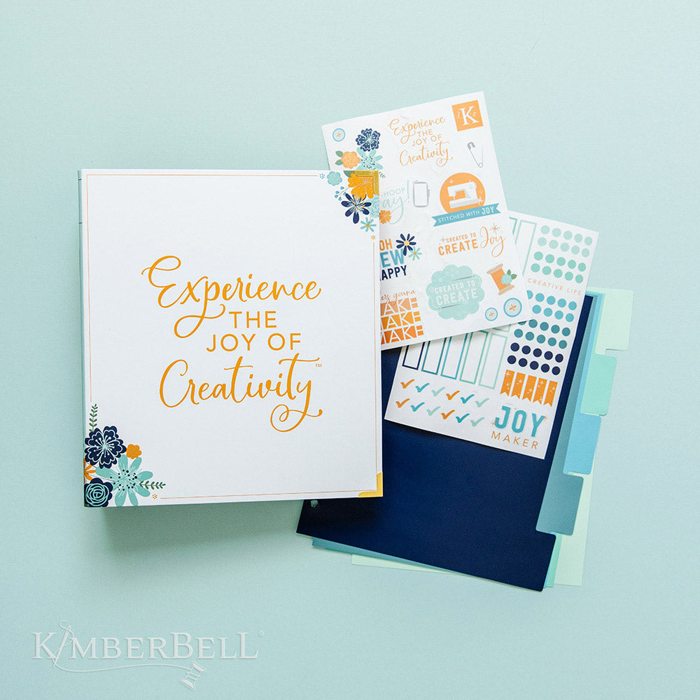 Inspire yourself with the Experience the Joy Binder (KDMR131) by Kimberbell. Each 3" binder includes 5 tab dividers and 2 sheets of stickers, plus gold metal corners to ensure the durability. This photo shows it comes with 2 sticker sheets and a set of 5 tab dividers.