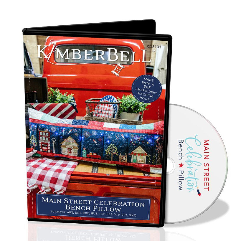 Join the Main Street Celebration with Kimberbell and create your own bench pillow with pennants, banners, and patriotic bunting while fireworks burst in the night sky. It features fun embellishments, like fairy lights, embroidery leather, applique glitter, and more to make your pillow really sparkle and shine.