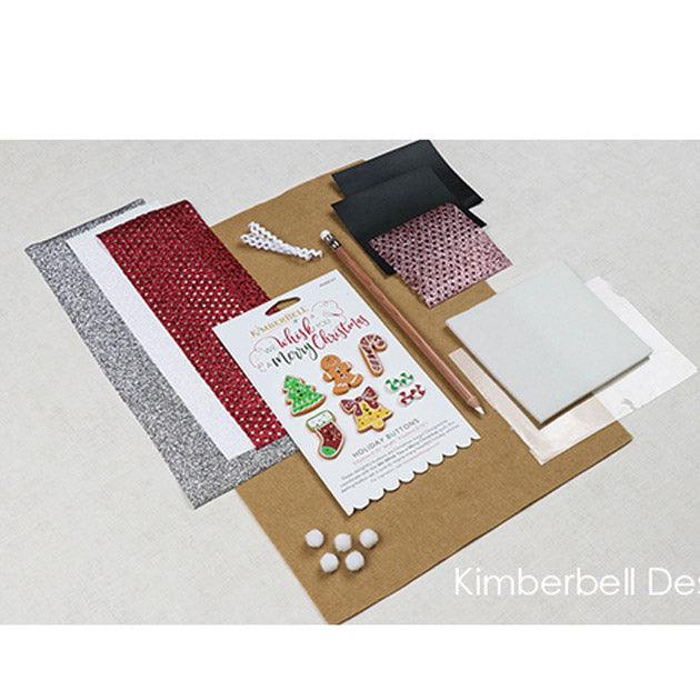 We’ve gathered all the trimmings to complete your We Whisk You a Merry Christmas Quilt in the We Whisk You a Merry Christmas Embellishment Kit (KDKB166). Our delightful embellishment kit is a joy to unwrap, with clear vinyl and applique glitter, designer holiday buttons, marshmallow poms, chalk fabric, and more! Photo shows the contents of the package.