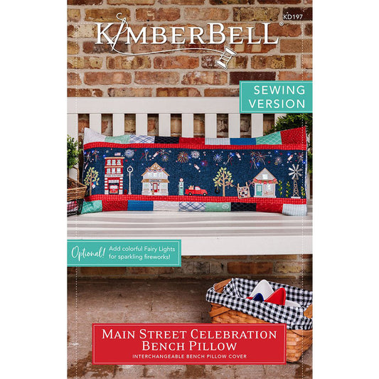 Join the Main Street Celebration (KD197) with Kimberbell and create your own bench pillow using a standard sewing machine. This fun bench pillow pattern pulls out all the stops as it dresses up downtown with pennants, banners, and patriotic bunting while fireworks burst in the night sky. Picture shows the front cover of the pattern.