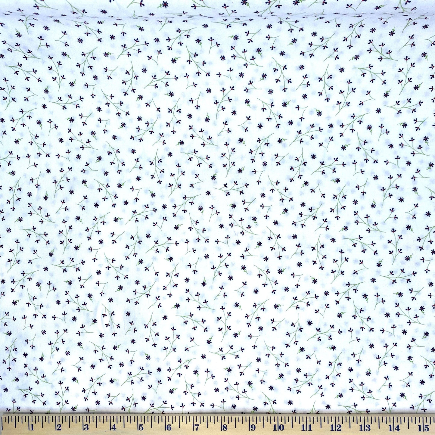 The mini navy flowers are placed on a white background and are a compliment to the summer-time theme of Red, White & Bloom by Kim Christopherson of Kimberbell for Maywood Studio. Although a coordinate of the original line, this fabric is a great alternative to a solid or tone on tone fabric when a white background color is needed. Stitcher's Joy
