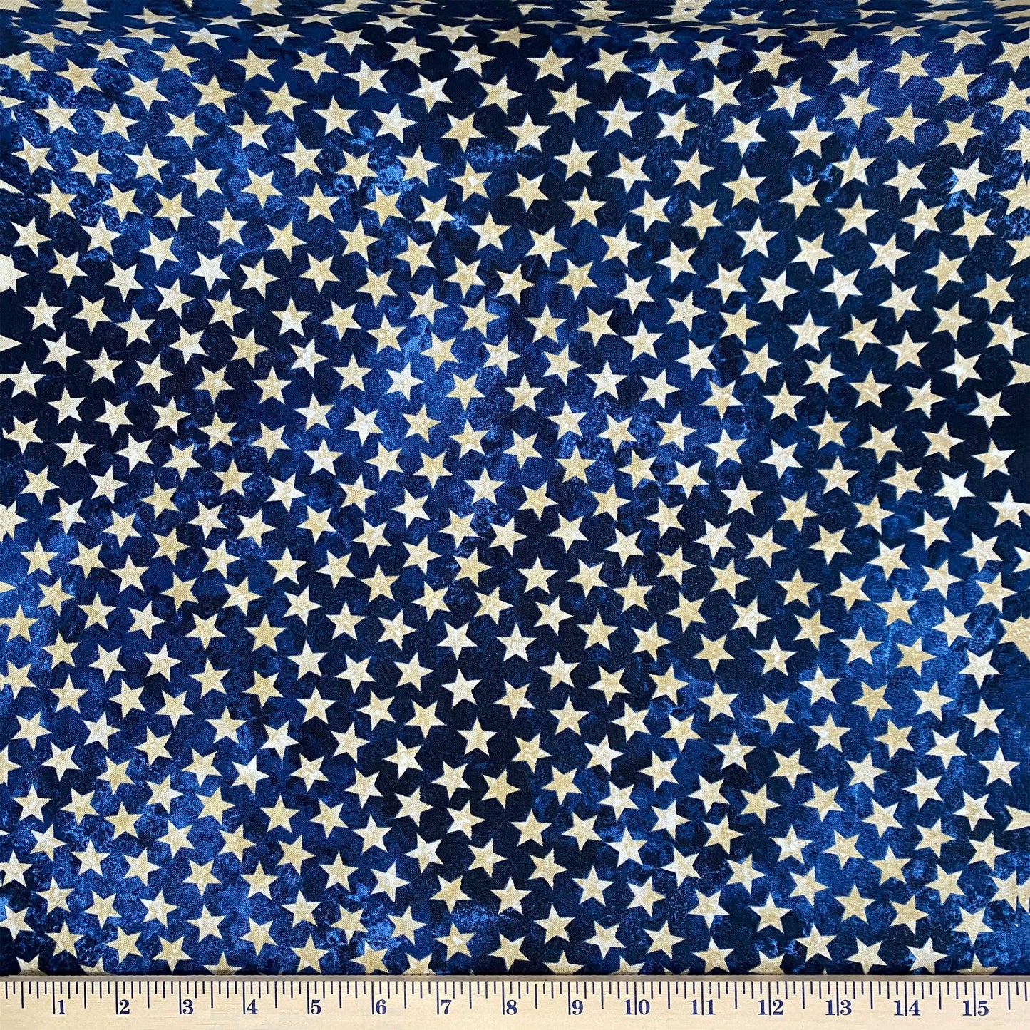 Cream stars on mottled navy background from the Stars and Stripes 10 - Stonehenge Anniversary Special Edition by Linda Ludovico & Deborah Edwards for Northcott fabrics (39101-49). Stitcher's Joy