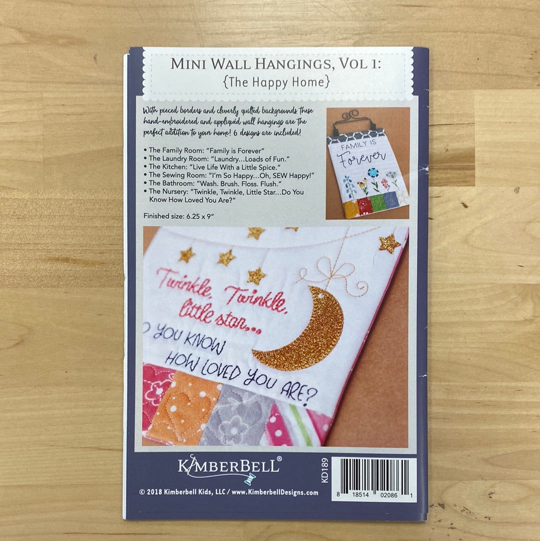 Add some charm to your home decor with our Mini Wall Hangings! These adorable mini quilts are perfect for any room in The Happy Home. Transform your space with a touch of sewing magic. Each wall hanging is made on a regular sewing machine. Photo features product back.