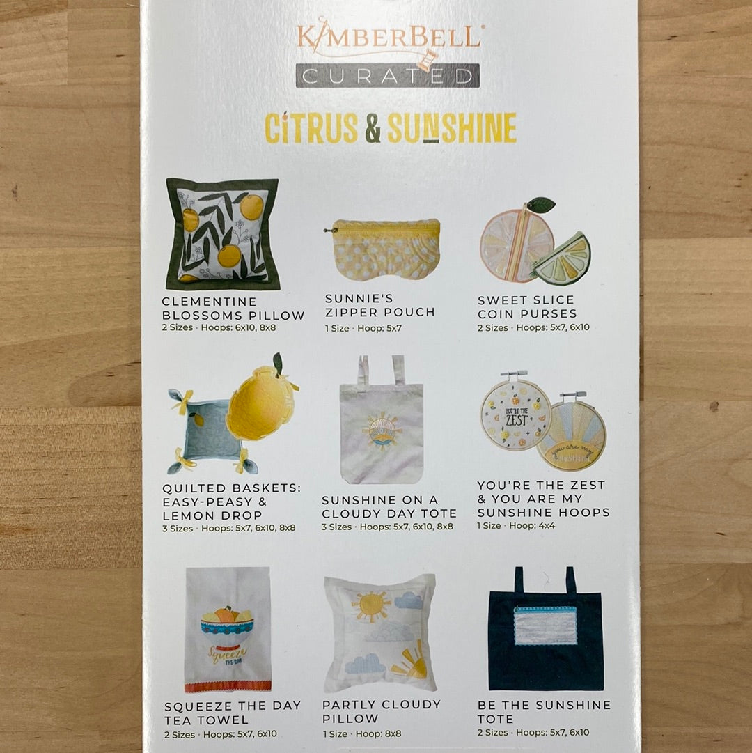 Bright, beautiful, and bursting with creativity, Kimberbell Curated: Citrus & Sunshine includes 12 fresh and fabulous machine embroidery projects. “Squeeze the Day” with a colorful tea towel, and “Be the Sunshine” with a pretty Pocket Tote! Photo shows product back.