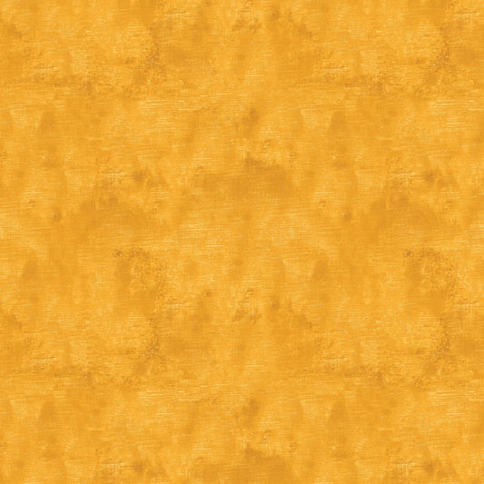 Chalk Texture 9488-32 is a marigold yellow cotton fabric with a mottled tone on tone texture with lightly brushed markings.