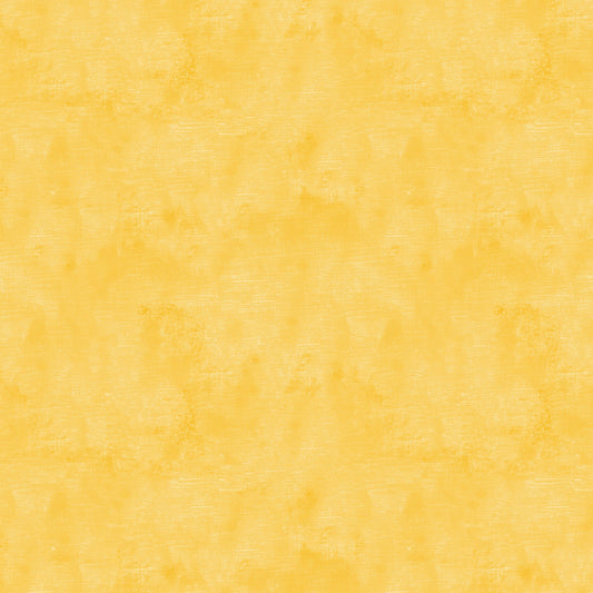Chalk Texture 9488-33 is a yellow cotton fabric with a mottled tone on tone texture with lightly brushed markings.