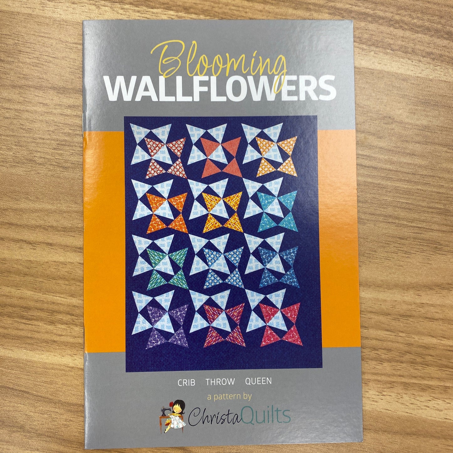 Created by Christa Watson of Christa Quilts, this fun pattern uses one simple block to create a playful quilt. The photo shows the front cover of the pattern with a vibrant quilt sample.