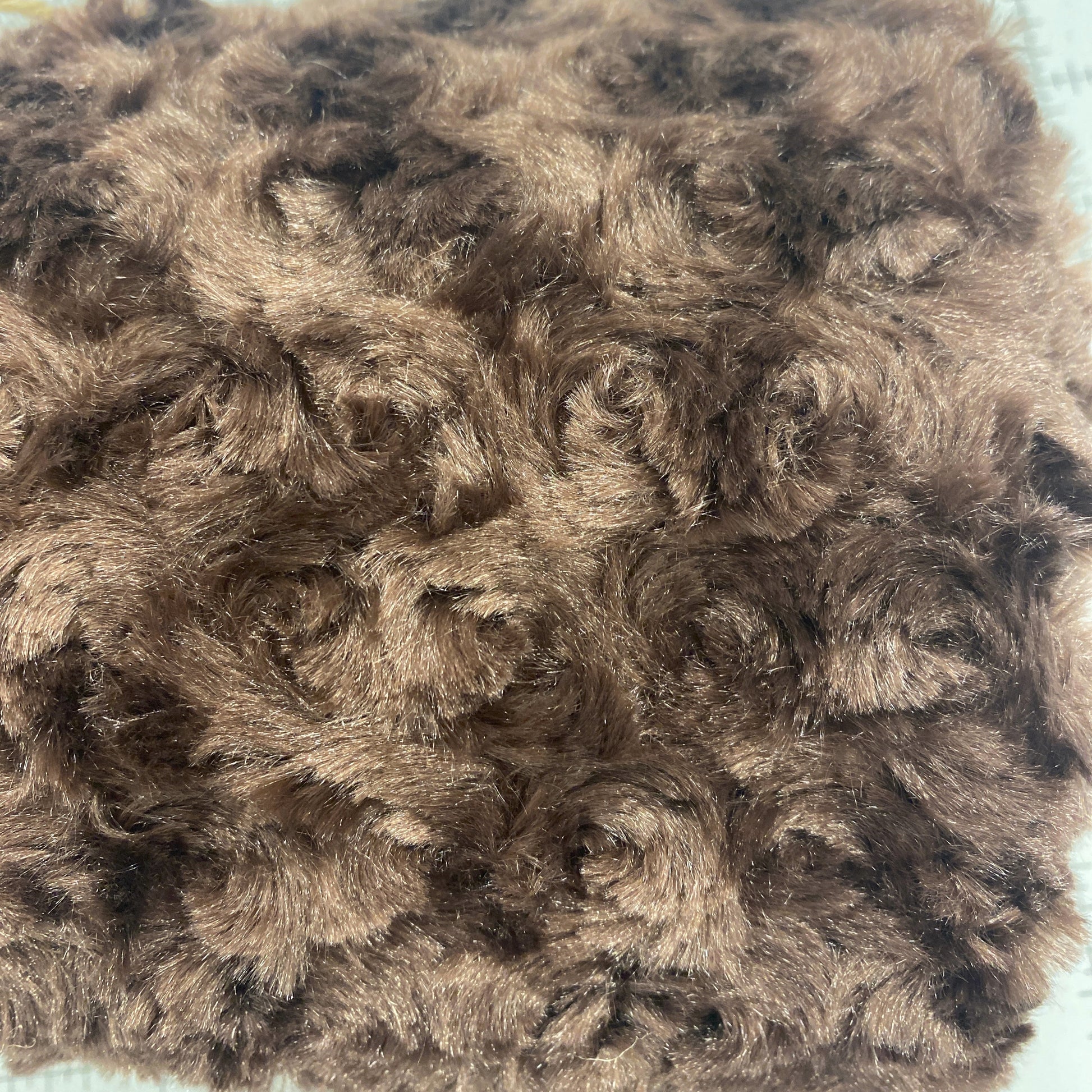 The soft texture of this minky is a pleasure to run your hands through. Use it back a quilt or make stuffed animals. Photo shows the texture of the fabric.