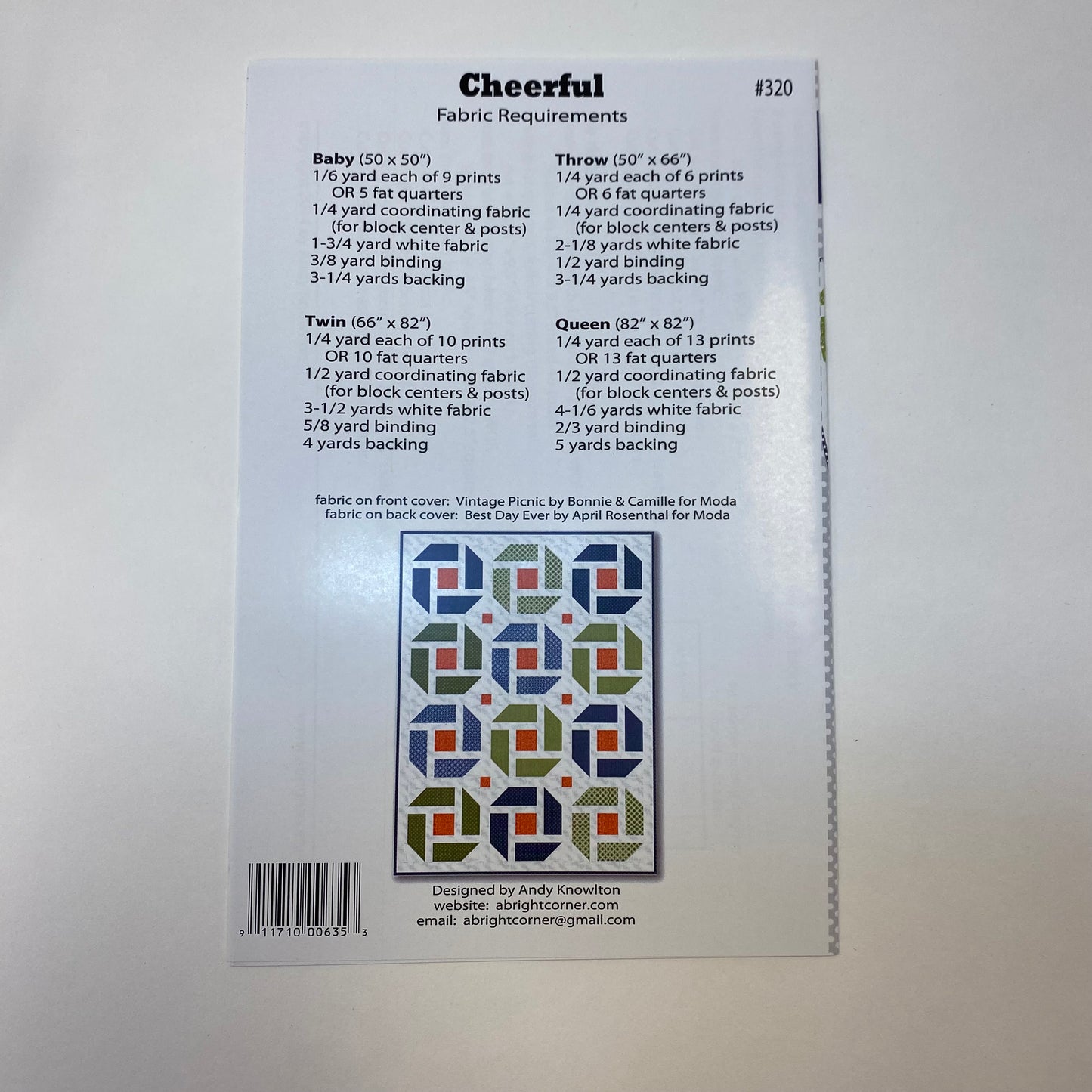 Back of a sewing pattern envelope for 'Cheerful' fabric pattern #320, showing fabric requirements for different quilt sizes, a color sample grid, and a barcode on a white background.