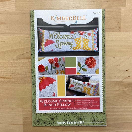 Welcome spring with this playful pattern by Kimberbell for your regular sewing machine! With appliques of umbrellas, rain boots, and dimensional flowers, this pattern will add a touch of whimsy to any bench or seat.