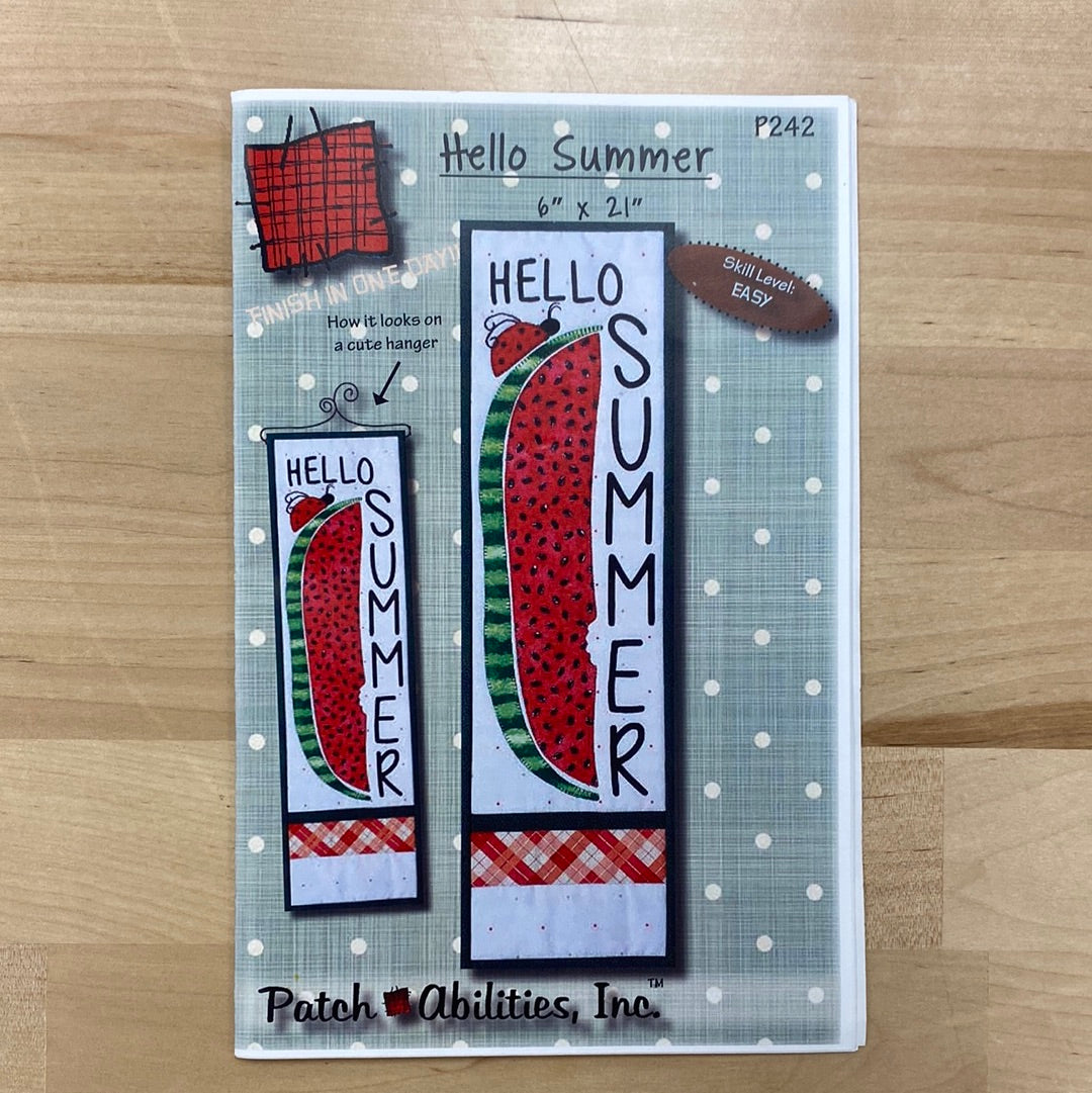 Get ready to say "Hello Summer" (P242) in the most fun and unique way with our mini quilt and applique project by PatchAbilities! This cute design features a long watermelon slice and a playful ladybug. Photo shows the front cover of the pattern, which includes a picture of the finished project and finished project on the hanger.