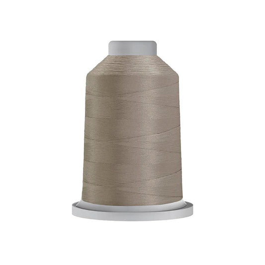 Glide 40 wt. Trilobal Polyester by Fil-Tec come in a mini spool of 1,100 yards of thread. Cool Grey 3 (10CG3) is a medium shade grey, perfect for woodland creature or construction embroidery and thread-painting. Photo shows the spool. Stitcher's Joy
