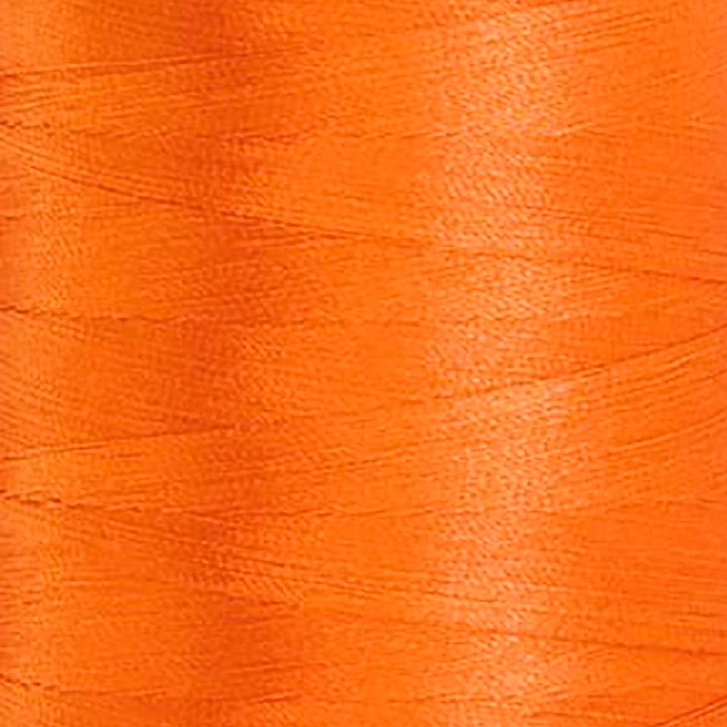 Glide 40 wt. Trilobal polyester thread by Fil-Tec offers superior coverage in each 1,100 yard mini spool. Lava (5158) is a universal orange in a bright shade. The photo shows the detail of the thread. Stitcher's Joy