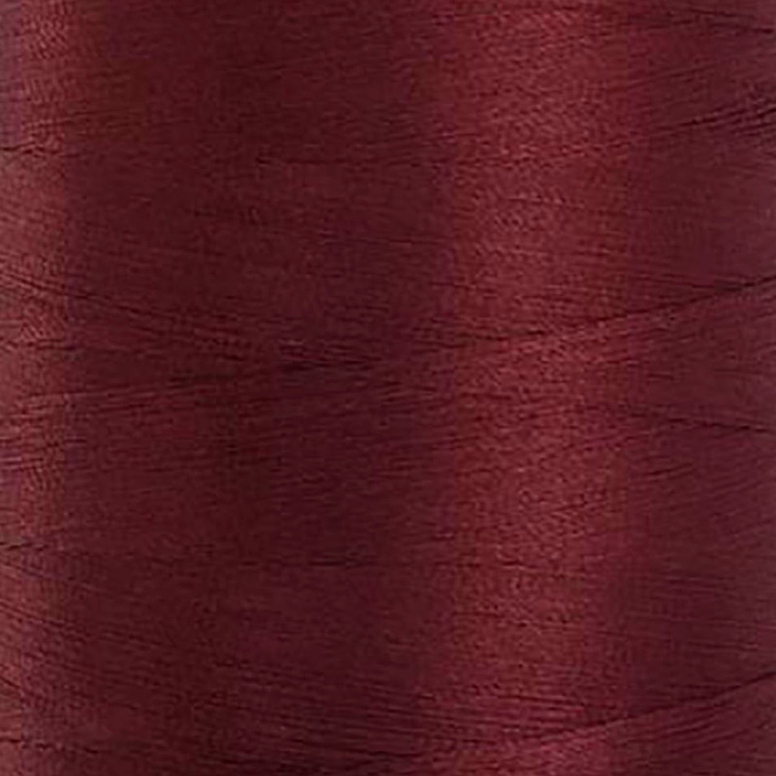 Glide 40 wt. Trilobal polyester thread by Fil-Tec offers superior coverage in each 1,100 yard mini spool. Maroon (70209) is a universal maroon. The photo shows the detail of the thread. Stitcher's Joy