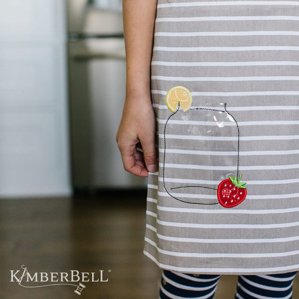 Kimberbell Over the Edge Applique for Spring and Summer (KD588) features 3D applique, plaques, and fun pockets. This photo shows an example of jar made of clear vinyl with accents of an applique lemon and strawberry.