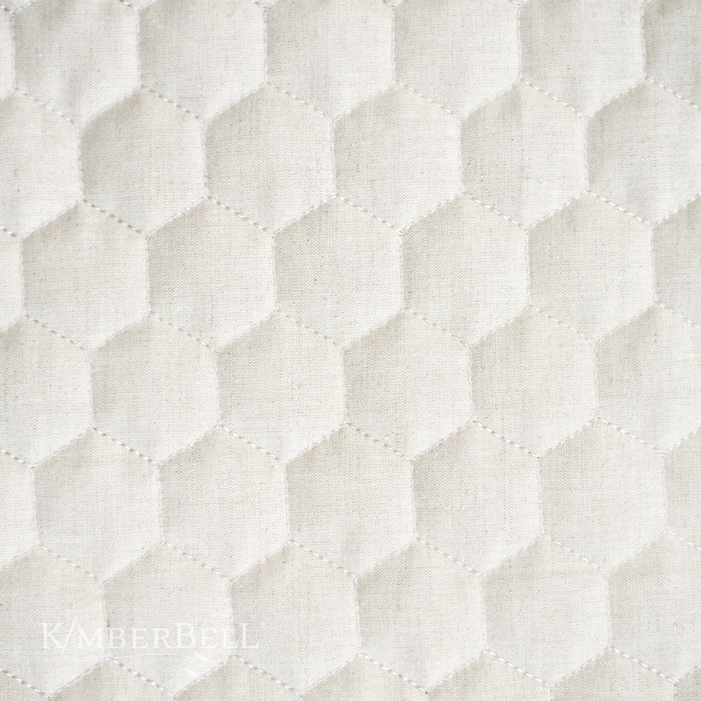 Create beautiful decor for your home with Kimberbell's Oat Linen 19" x19" hexagon quilted pillow blank (KDKB260)! Kimberbell’s Quilted Pillow Blanks are easy to embellish with serged, open side seams and a sewn-in zipper. Photo shows close-up of hexagon quilting detail.