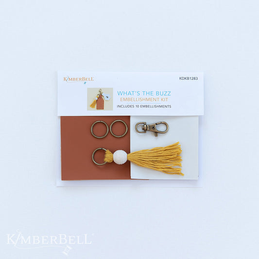 All the darling details for your What’s the Buzz key-chain project in one kit (KDKB1283)! Create your key-chain and lip balm holder with brass key-chain hardware, jump rings, a mustard tassel with bead, and Embroidery Leather in camel and white colors. Photo shows the front of the package.