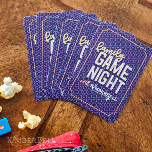 Family Game Night Playing Cards (KDMR108) by Kimberbell. In this family friendly deck of playing cards, standard suits are represented with jumbo symbols and numbers, making the cards easy to read. Photo shows the back of the cards laid out like playing a game.