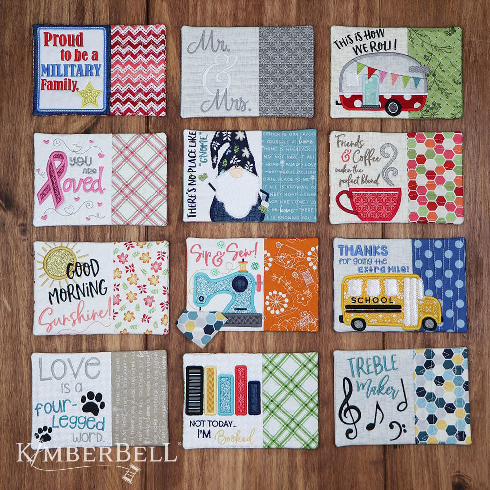 Kimberbell Mug Rug pattern for machine embroidery features small projects with fun sayings to liven up a desk or table. This photo shows an example of each of the 12 designs stitched out.