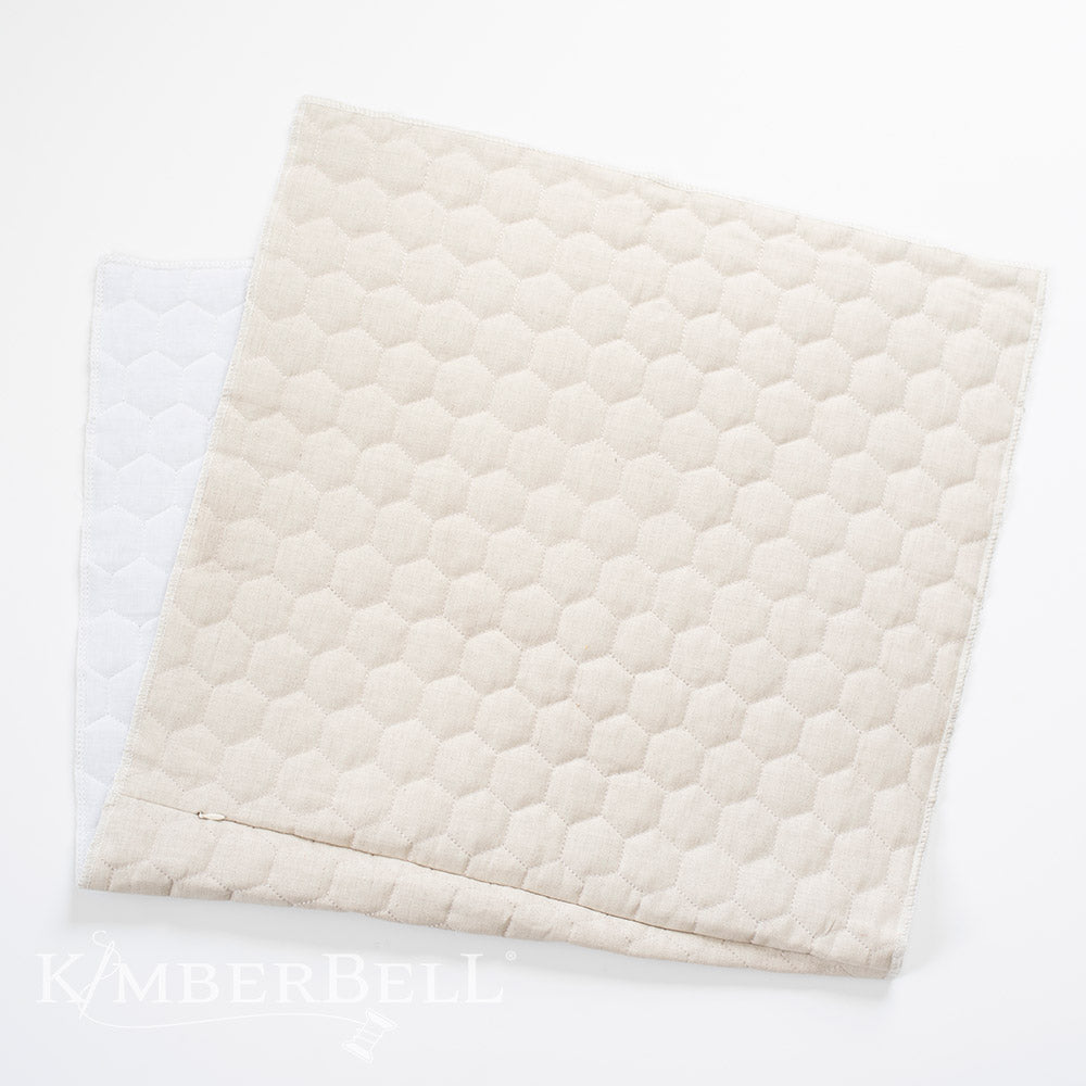 Create beautiful decor for your home with Kimberbell's Oat Linen 19" x19" hexagon quilted pillow blank (KDKB260)! Kimberbell’s Quilted Pillow Blanks are easy to embellish with serged, open side seams and a sewn-in zipper. Photo shows blank with open seam.
