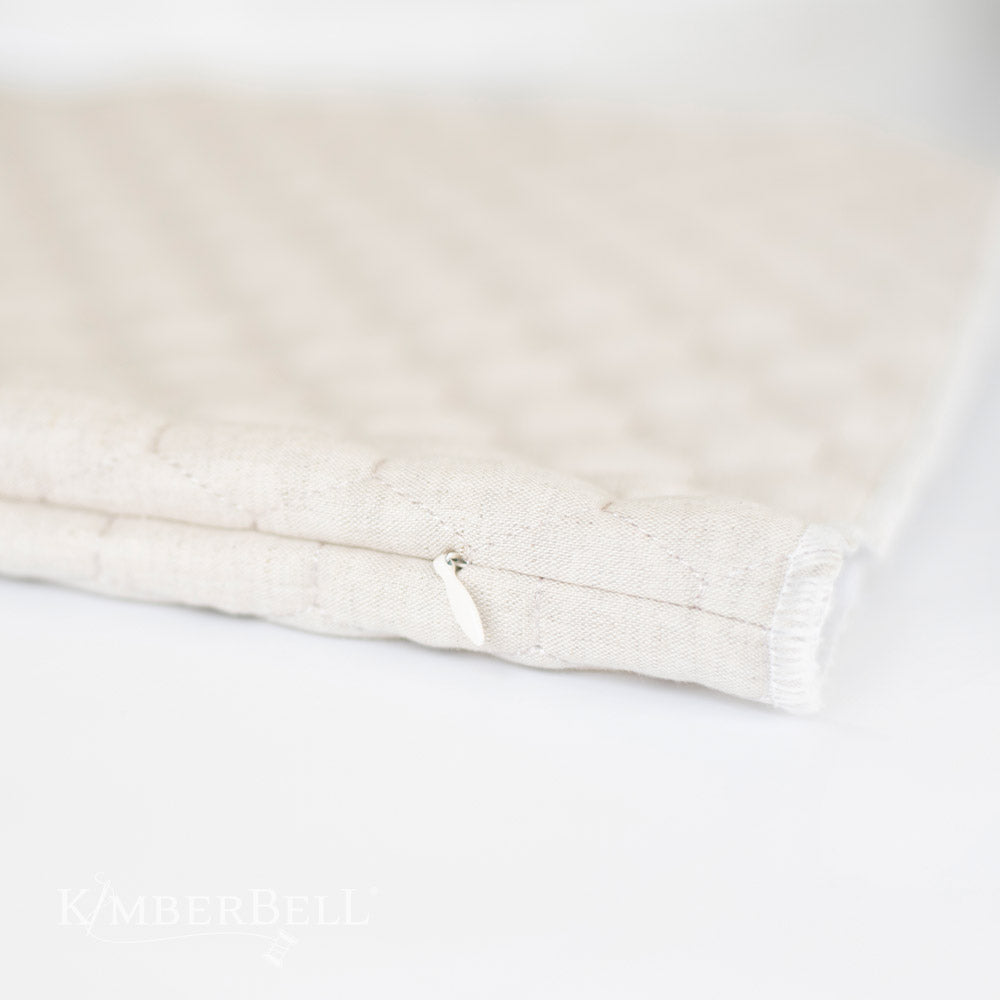 Create beautiful decor for your home with Kimberbell's Oat Linen 19" x19" hexagon quilted pillow blank (KDKB260)! Kimberbell’s Quilted Pillow Blanks are easy to embellish with serged, open side seams and a sewn-in zipper. Photo shows close-up of invisble zipper on unfinished pillow.