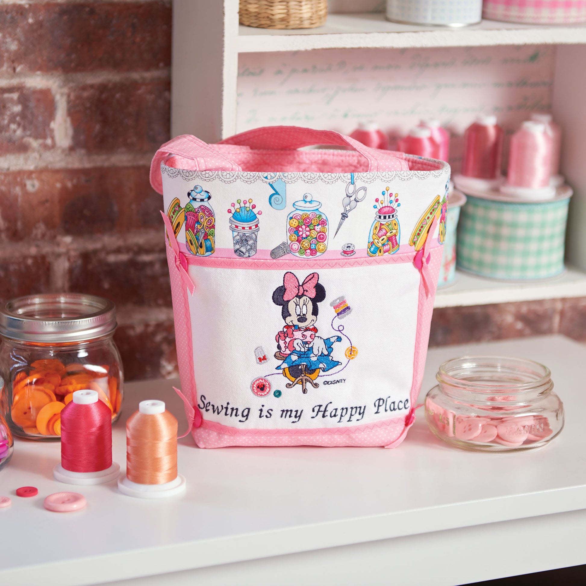 Pink sewing bag with Minnie Mouse character design on a shelf with sewing supplies