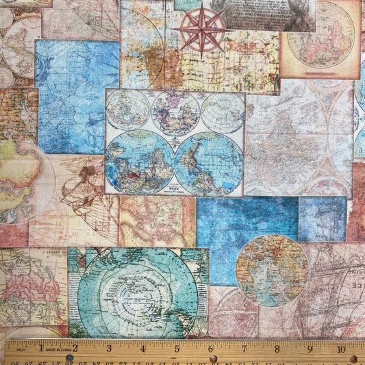 Vintage-style world map patchwork fabric with a wooden ruler showing 12 inches at the bottom for scale.