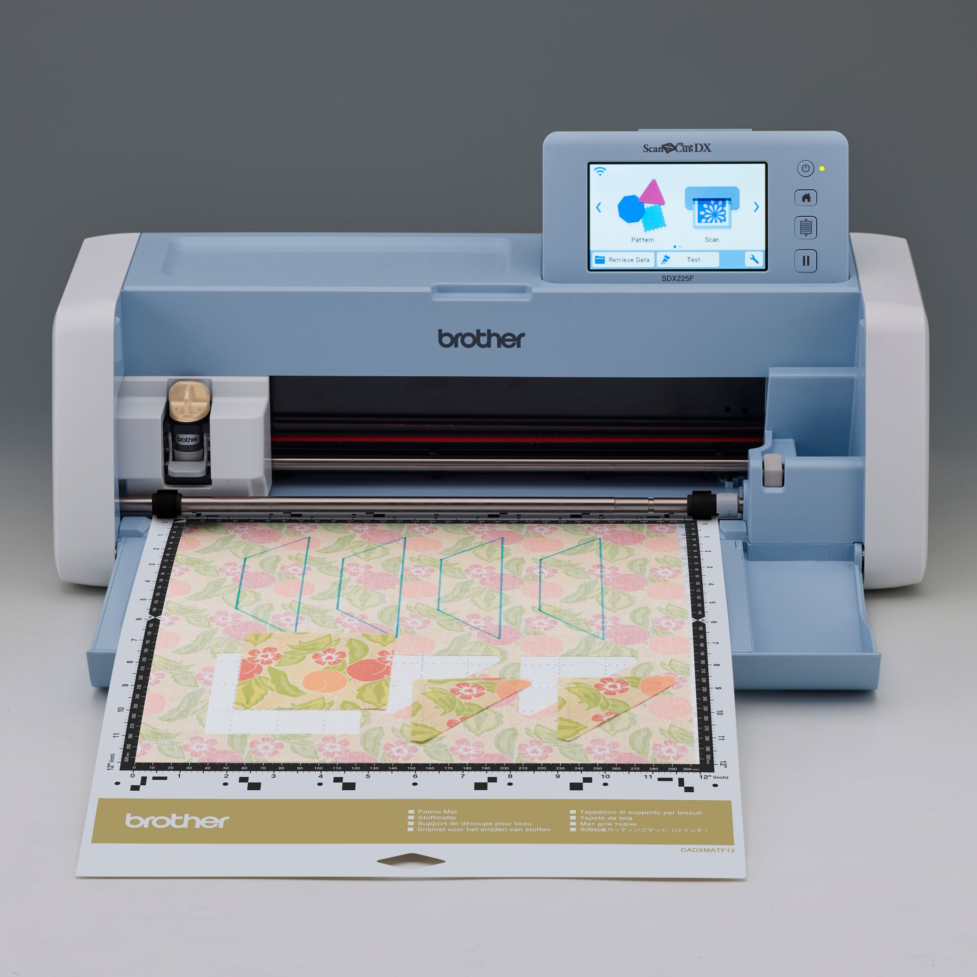 Brother SDX225F cutting machine with a piece of fabric on a gray background