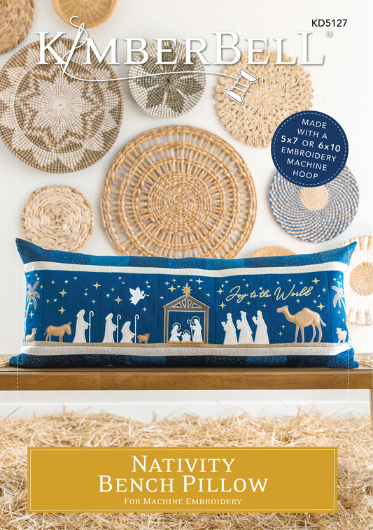 Celebrate the season with Kimberbell’s Nativity Bench Pillow (KD5127)! The holy family is safely ensconced in an applique stable, while Fairy Lights twinkle in the starry night sky. Shepherds and wise men are coming to greet them, a shimmering glitter star and angel guiding their way! Photo shows the finished pillow on the front cover of the product.