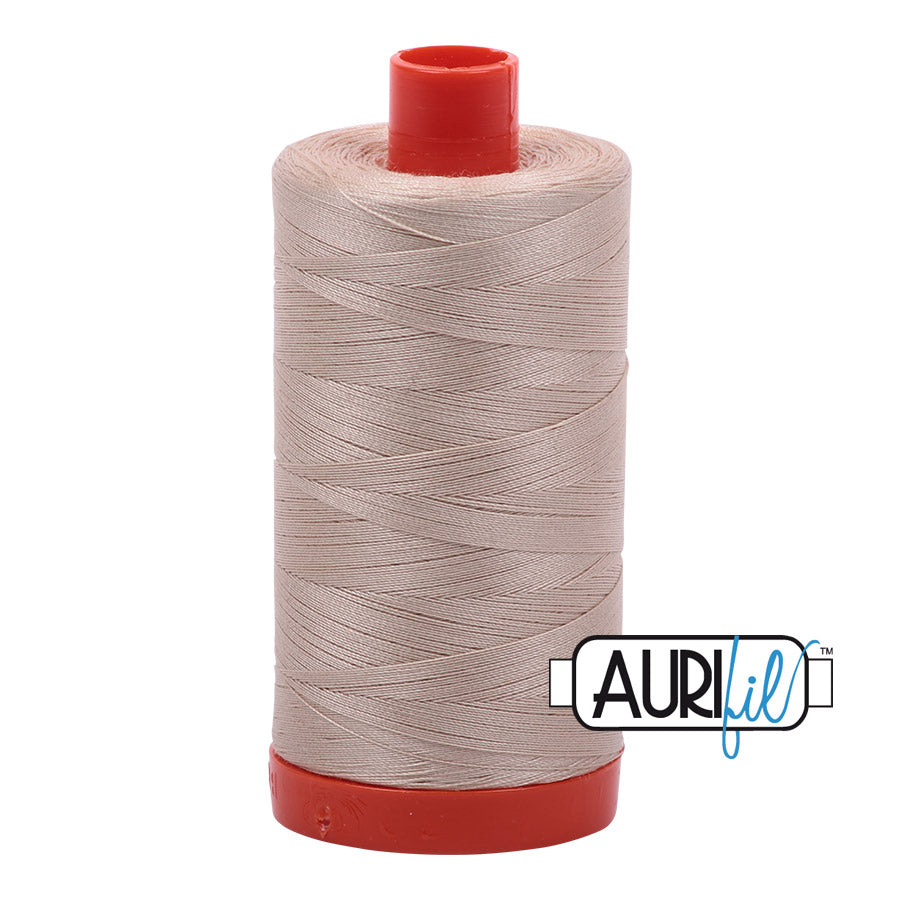 Aurifil 50 wt. cotton thread offers versatility, strength, and radiant color with very little lint on each 1,422 yard large spool. Ermine (2312) is a medium shade of true tan with yellow to brown undertones. Stitcher's Joy