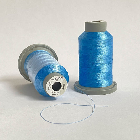 Glide 40 wt. Trilobal polyester thread offers superior strength, coverage, and consistency on each 1,100 yard mini spool. Azure (30283) blue is a slightly darker than a baby blue, but still maintains a light blue richness. Stitcher's Joy