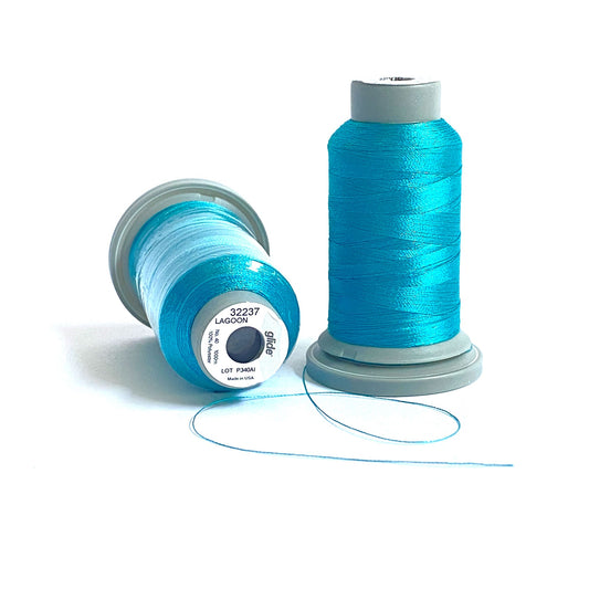 Glide 40 wt. Trilobal polyester thread offers superior coverage in each 1,100 yard mini spool. Lagoon (32237) is perfect for the aqua colors of the tropics in an embroidery or thread-painting project. Stitcher's Joy