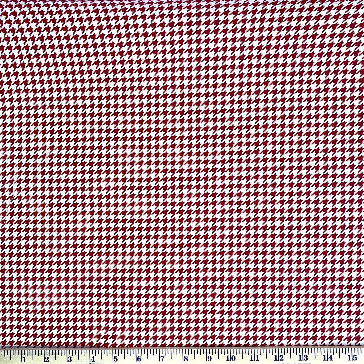 Red on White Houndstooth from the Kimberbell Basics line designed by Kim Christopherson for Maywood Studio. This fabric features a small red houndstooth print on a white background and is a fantastic choice for adding texture and color to a quilt. Stitcher's Joy
