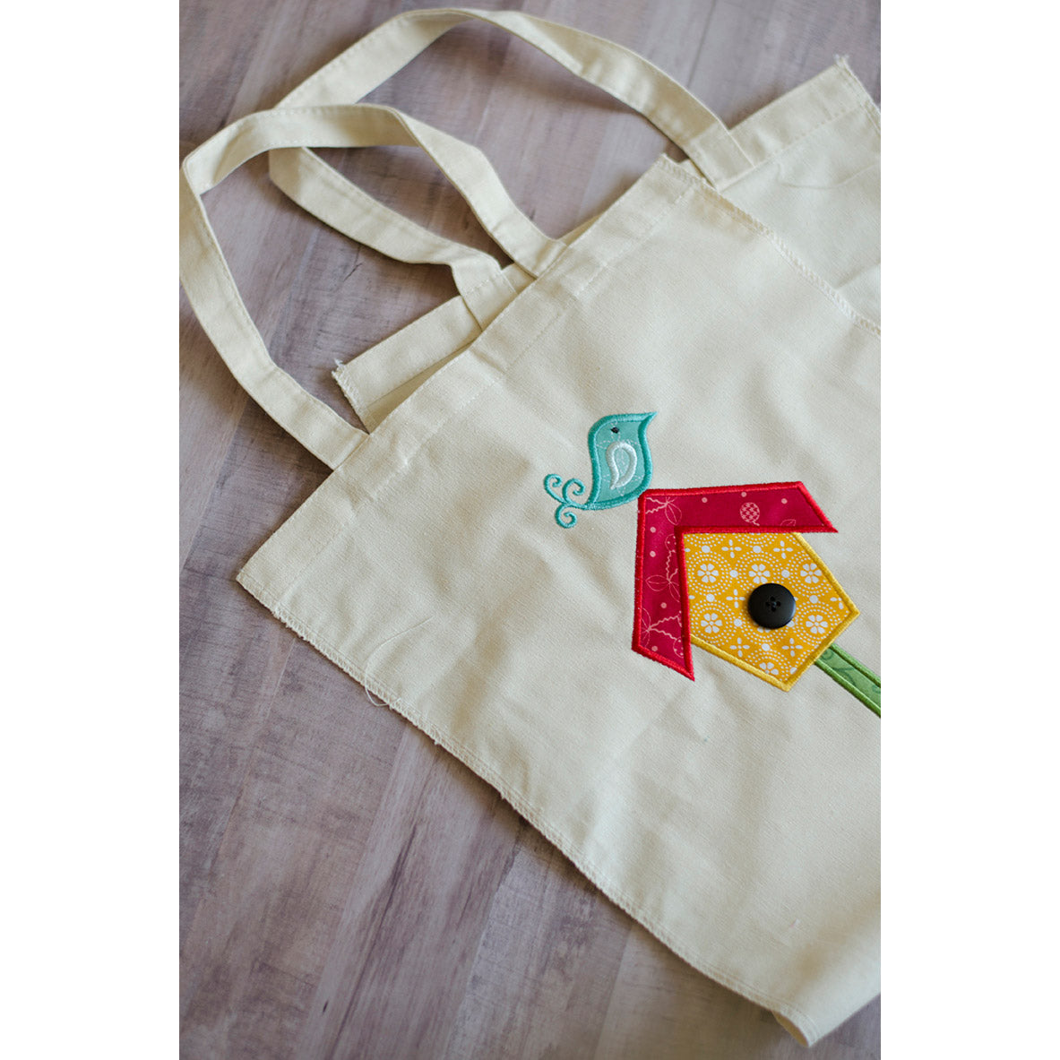 Kimberbell’s blank canvas totes (KDKB202) come without the side seams sewn up so it’s easy to hoop the bag itself, then add the adorable embroidery. The edges are serged too, so the bag won’t fray when you finish the side seams with a simple straight stitch.