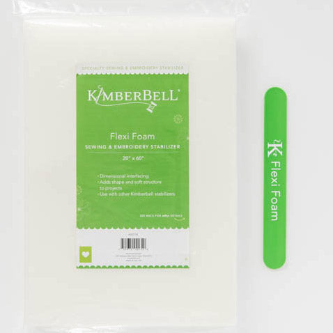 Flexi Foam (KDST132) by Kimberbell is color-coded in green to reflect it is part of Kimberbell’s Specialty Stabilizer line. Both sewists and machine embroiderers can use it to add flexible shape to bags, purses, frames, and more. The picture shows a package which contains one 20” x 60” sheet, and the color-coordinated stabilizer slap band. Stitcher’s Joy