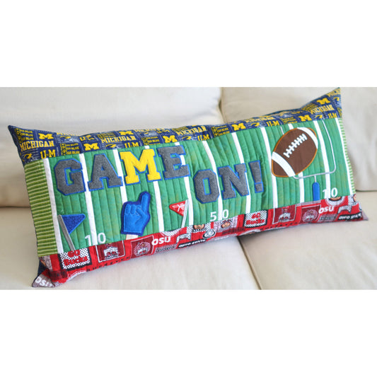 Cheer on your favorite team with the Game On! Bench Pillow Machine Embroidery Pattern (KD548) by Kimberbell. USe your favorite rival team fabrics, and enjoy the fun details of the field goal, football, and pennants.