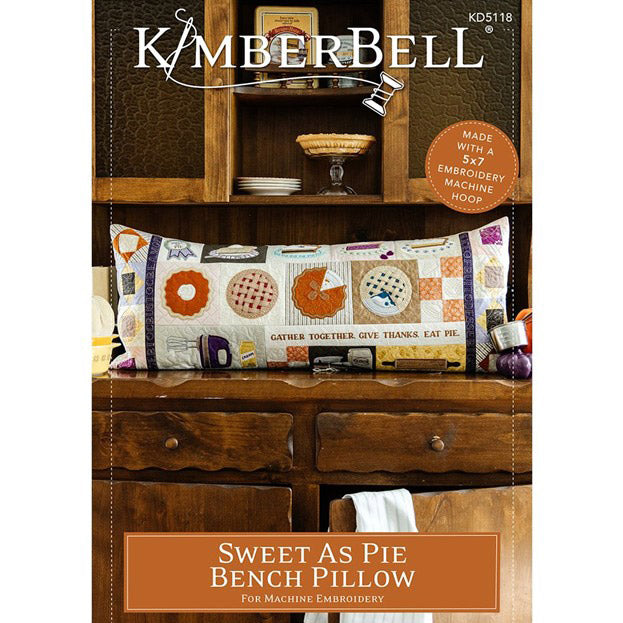 Kimberbell’s Sweet as Pie Bench Pillow KD5118 is a feast for the eyes! Create pie filling with fabric and iron-on vinyl, then top with a lattice crust, interchangeable ribbons, a cork rolling pin, and so much more to create a warm decor to be thankful for. All the designs are stitched in a 5x7 hoop and sewn together. This picture features the front cover.