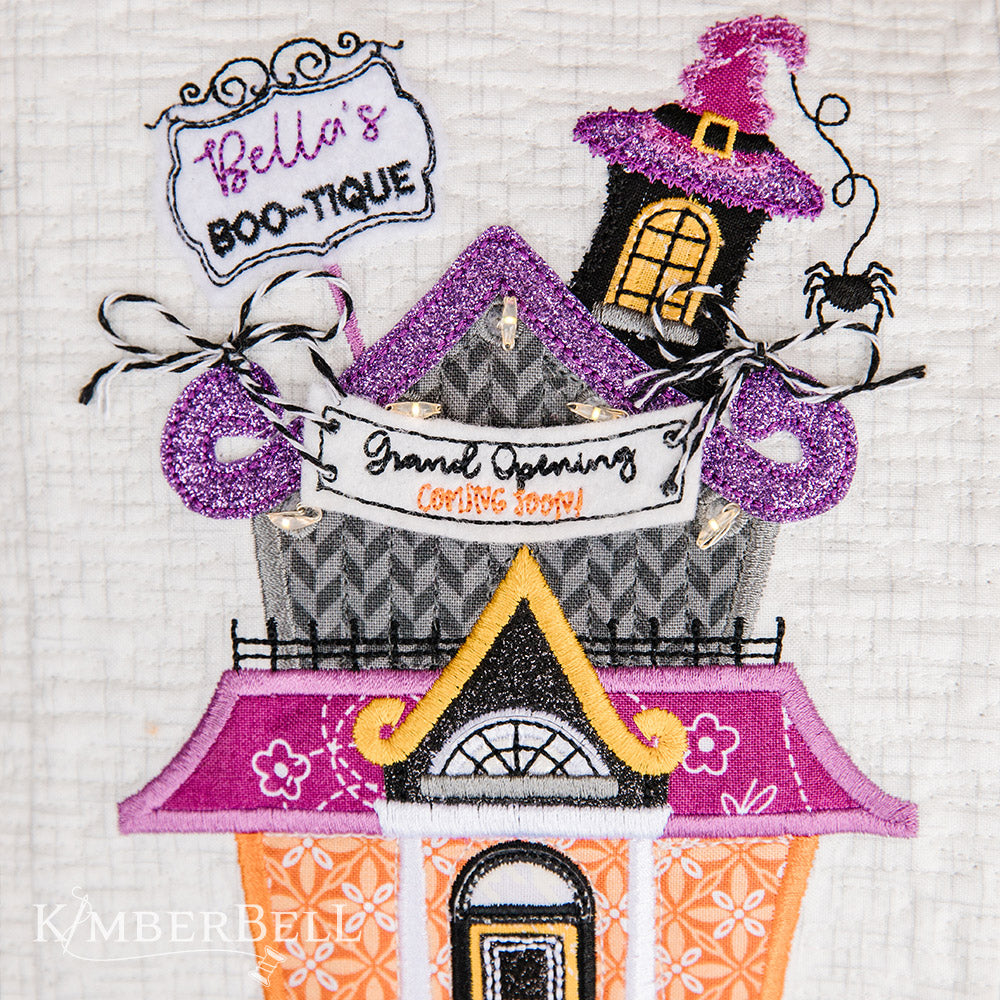 Take a stroll along Twilight Boo-levard (KD594) to visit all of your favorite haunts with this machine embroidery bench pillow pattern by Kimberbell.  With fairy lights, embroidery leather, buttons and mylar and more, the Twilight Boo-levard Bench Pillow is so enchanting, it’s almost scary!