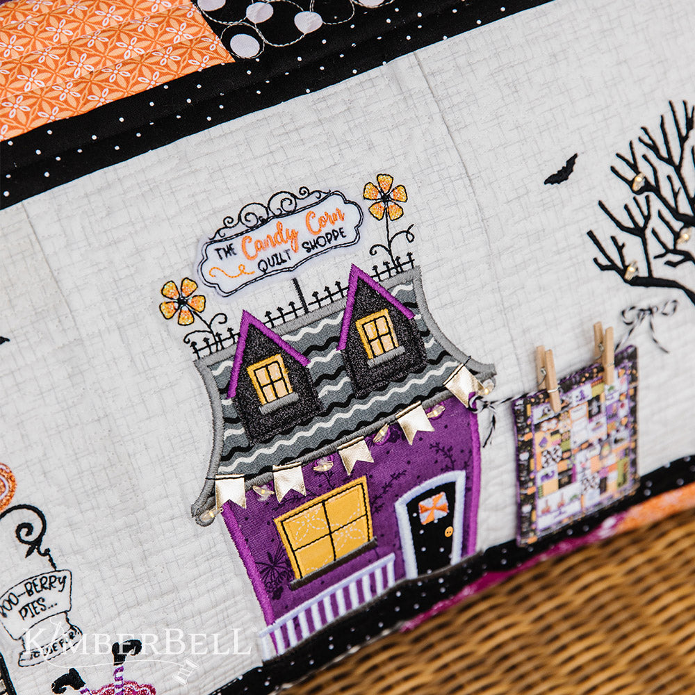 Take a stroll along Twilight Boo-levard (KD594) to visit all of your favorite haunts with this machine embroidery bench pillow pattern by Kimberbell.  With fairy lights, embroidery leather, buttons and mylar and more, the Twilight Boo-levard Bench Pillow is so enchanting, it’s almost scary!