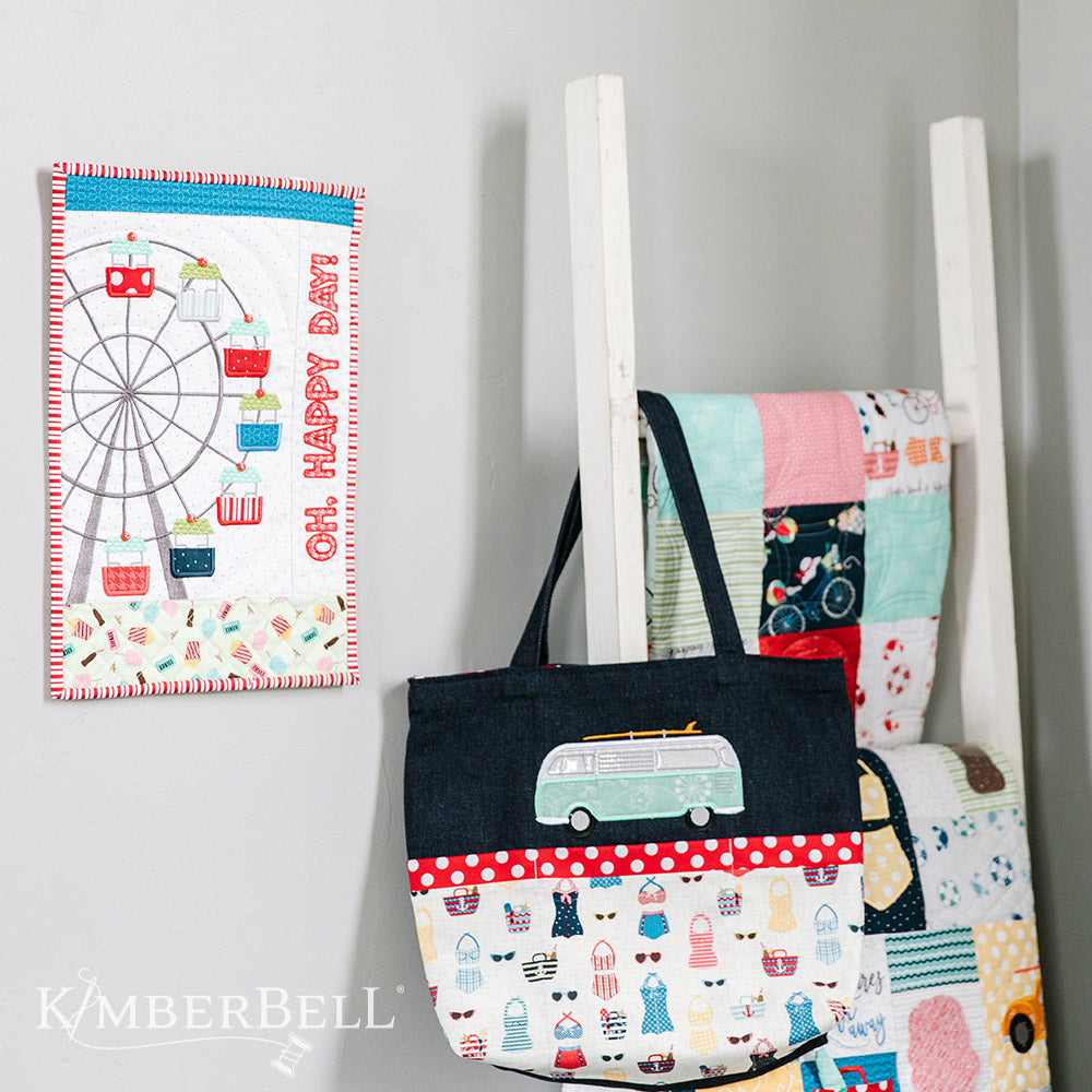 Take a leisurely stroll along a Vintage Boardwalk (KD807) with Kimberbell. This photo shows the additional projects that can be made with the pattern, including a tote bag with VW-style bus and wall-hanging with Ferris Wheel with little pockets.
